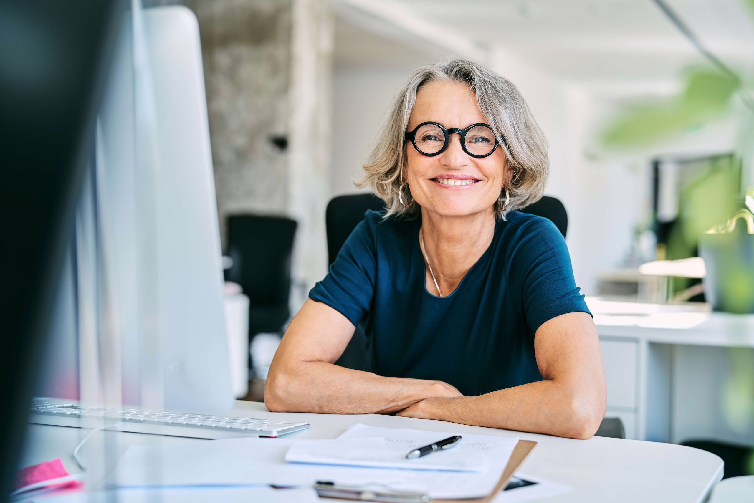 Smiling women in front of laptop at compliance online training